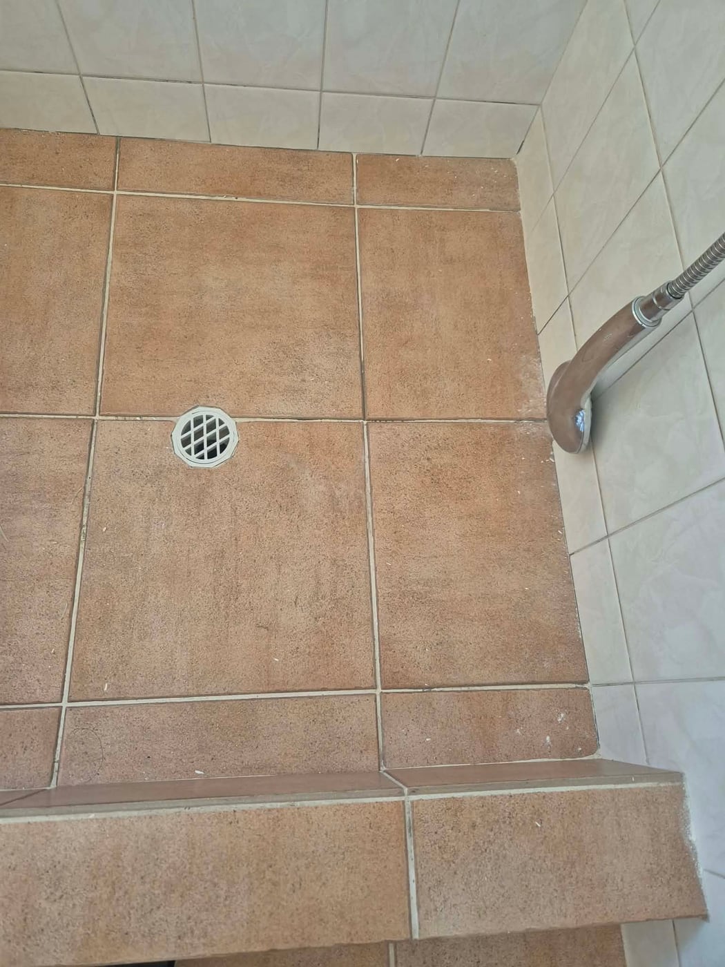 Freshly regrouted tiled shower floor