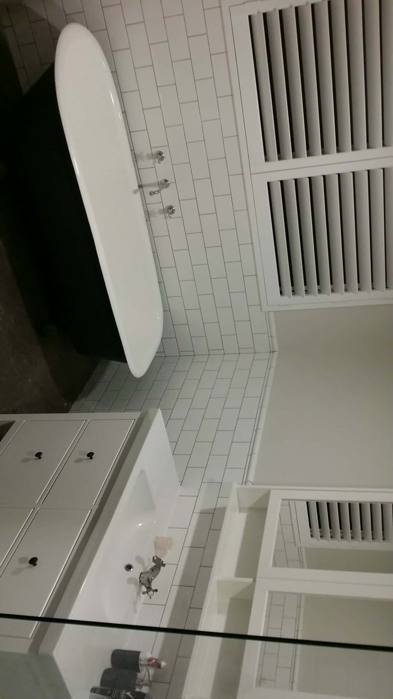 Bathroom with freestanding tub and subway tiles