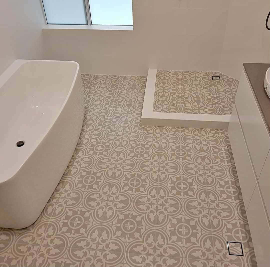 Bathroom with freestanding bath and patterned floor