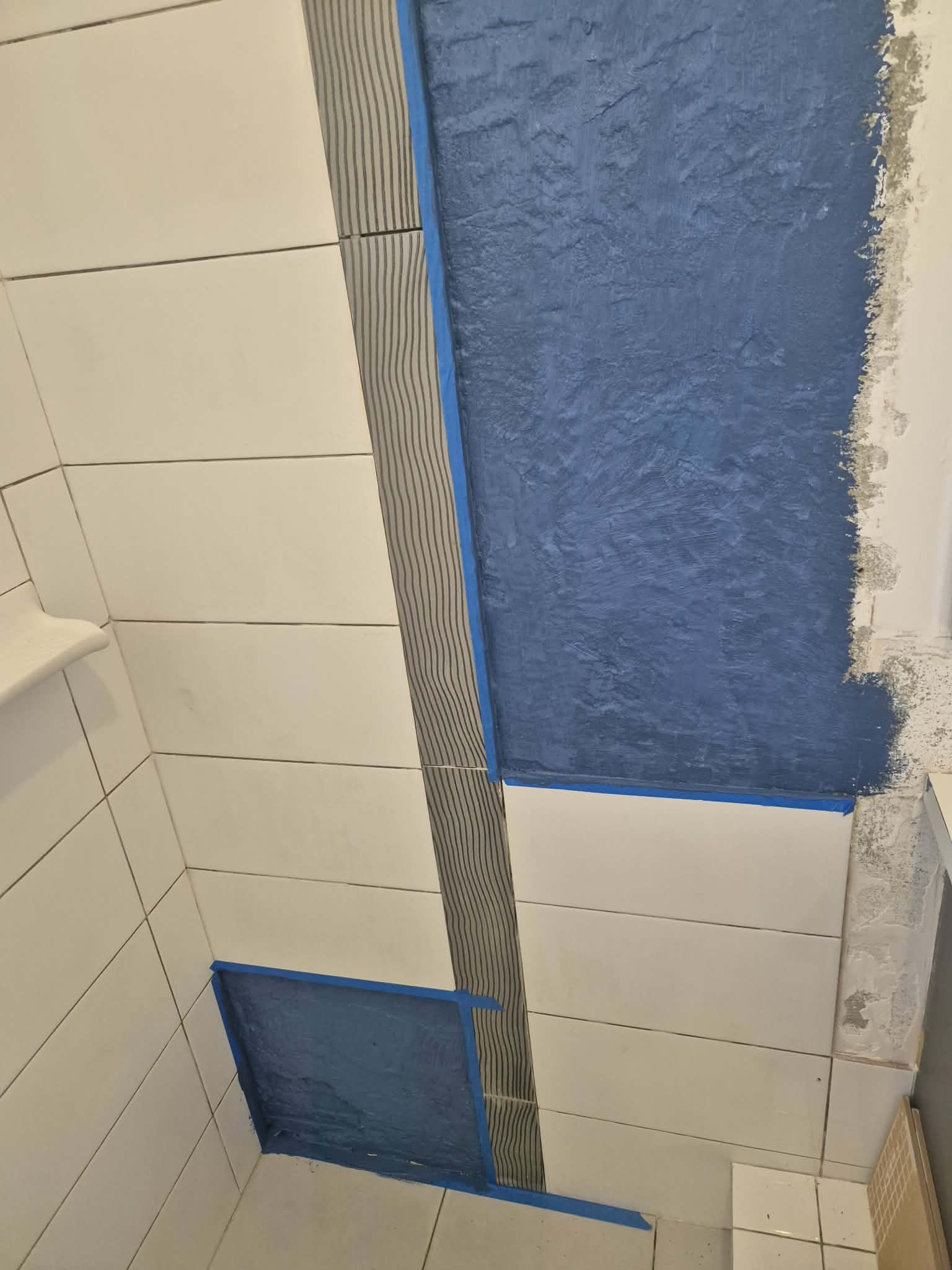 Waterproofing membrane being applied in a shower